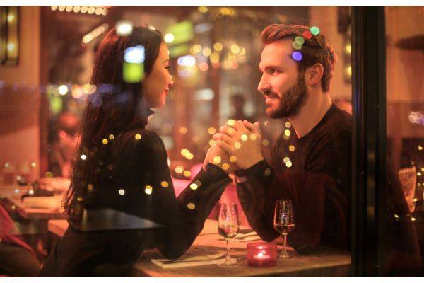 Couple holding hands at a restaurant