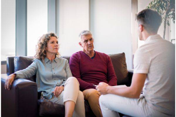 Older couple speaking with therapist