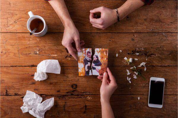 Couple holding a photo and ripping it