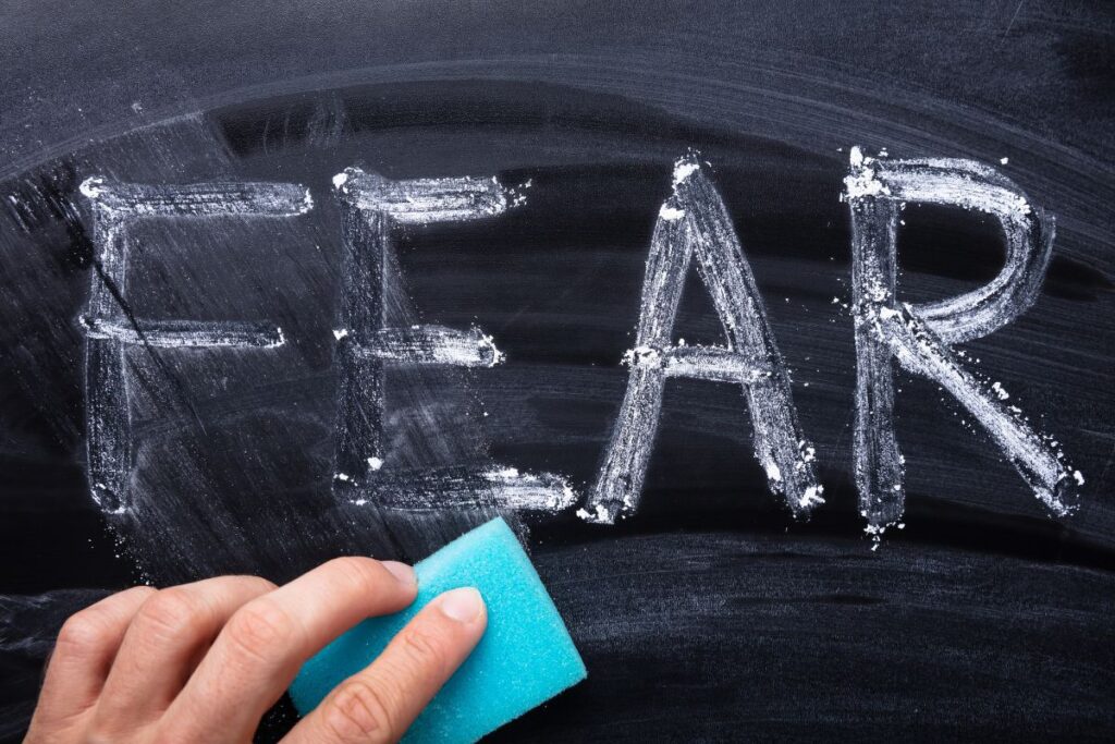 Fear written on caulk board. The word fear is half wiped off.