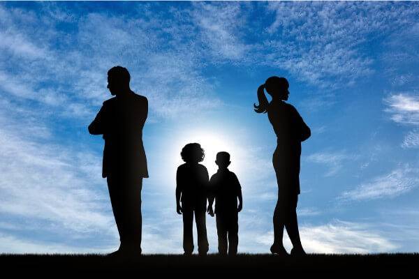 Mother and father facing away from each other and kids are in between parents