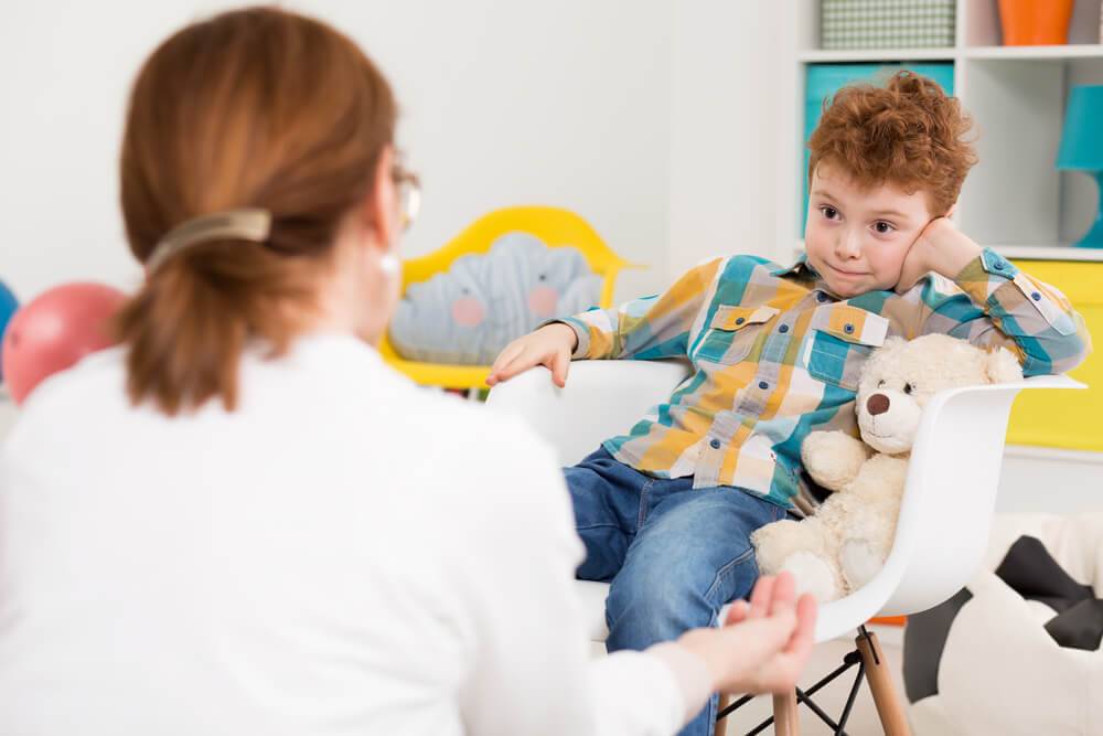 Therapist talking with a young boy