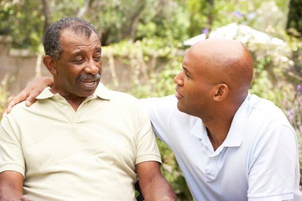 Elderly father talking to his adult son