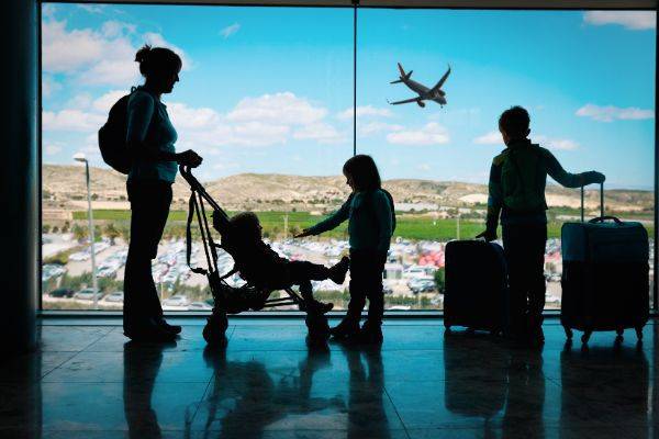 Mother in airport with her three children