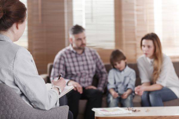 Mother, Father and son sitting in a therapists office