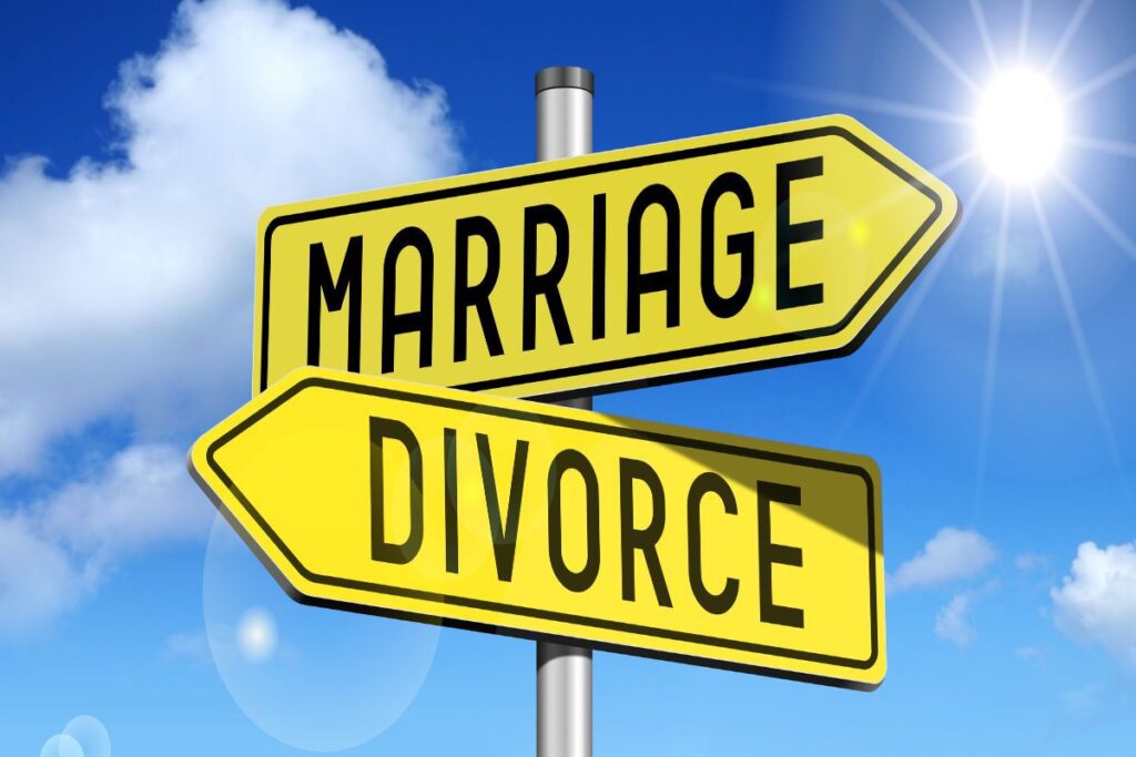 Street sign with two arrow signs. One sign says marriage the other says divorce.