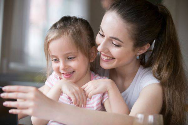 Woman with her daughter sitting on her lap