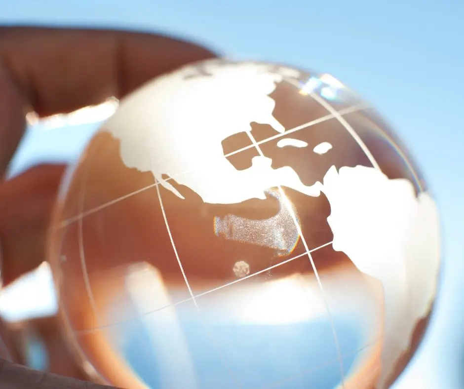 international travel after divorce: a transparent mini-globe in a hand 
