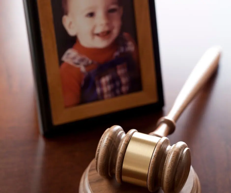 child custody and placement order: a picture frame with an image of a young boy, a gavel