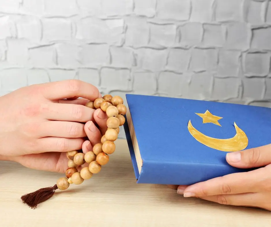a pair of hands holding a rosary and another pair is holding another religion book