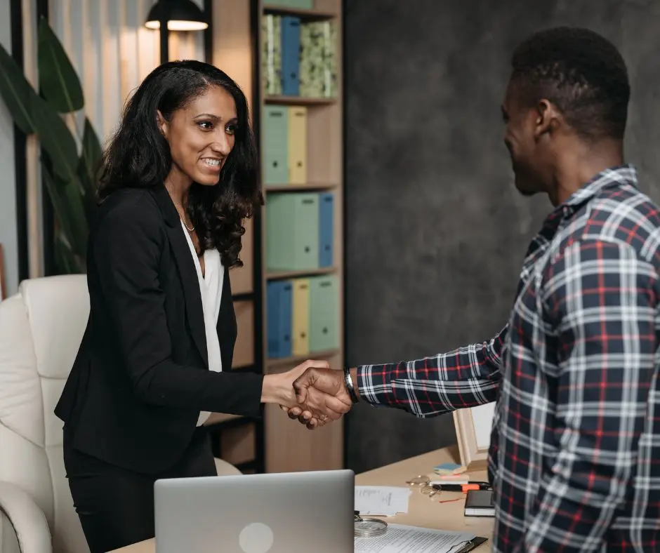 a man is shaking the hands of a female lawyer