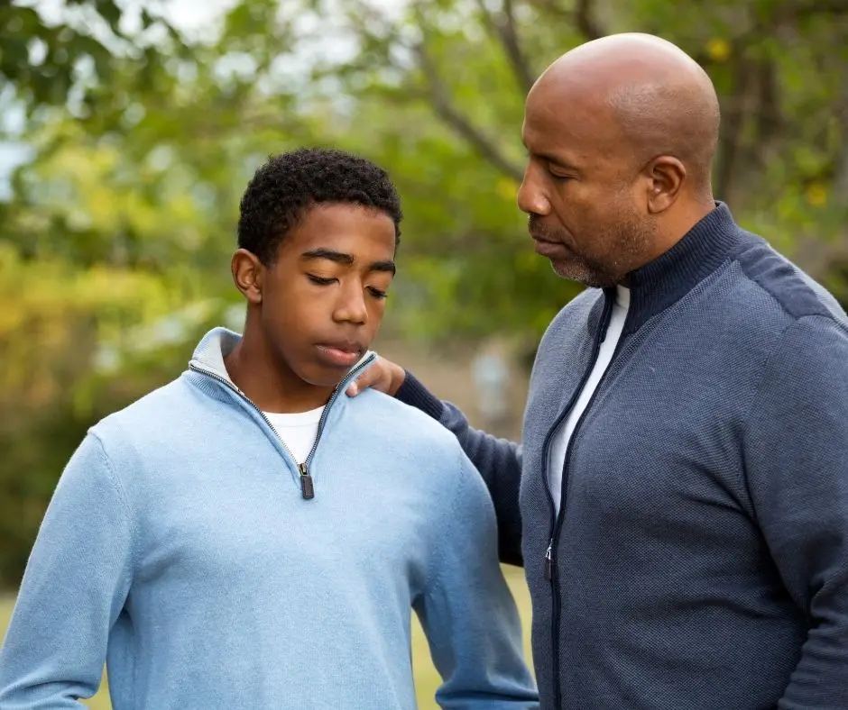 a father talking to his son as part of co-parenting teens after divorce