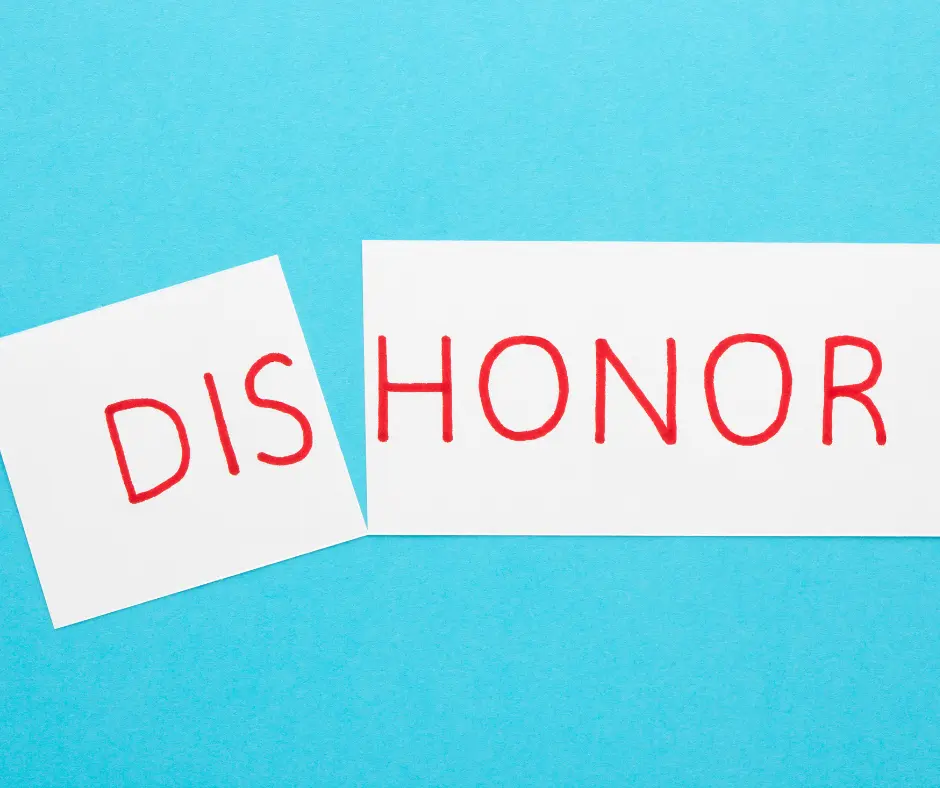 dishonor and divorce: a torn paper with a word "dishonor" 