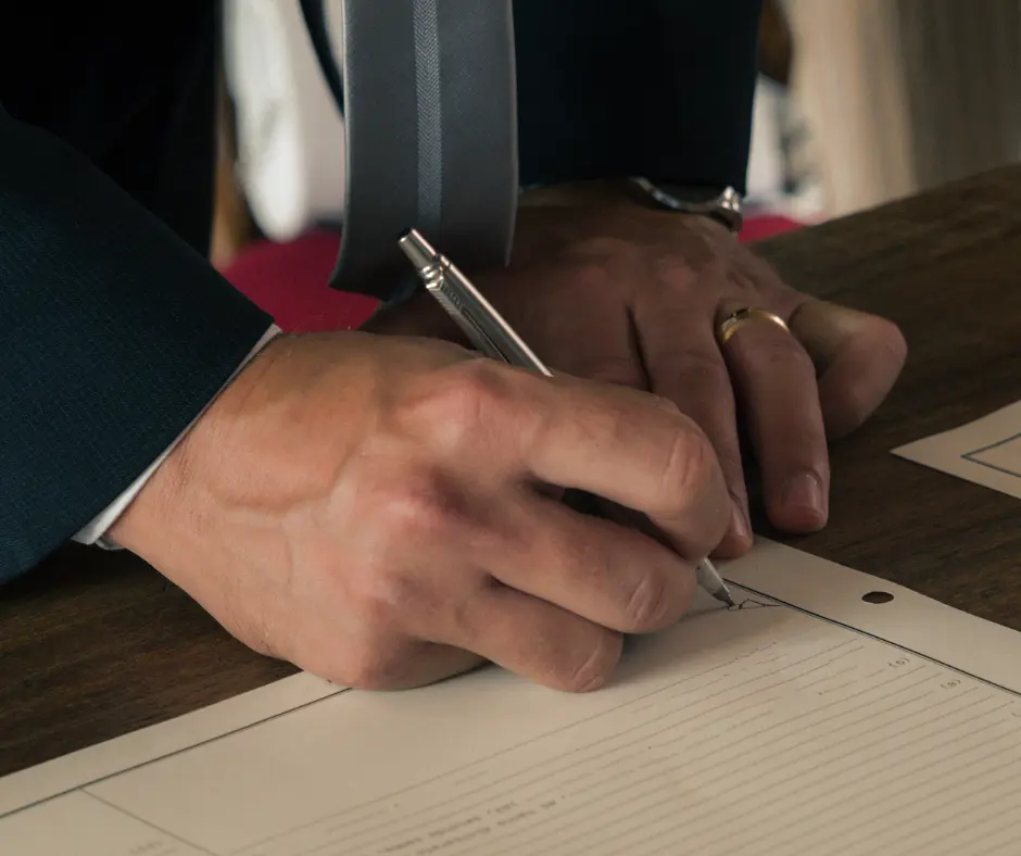 a man signing a marital settlement agreement