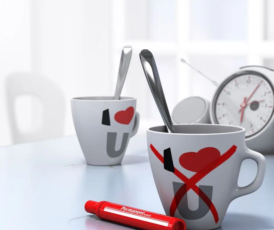 a clock with a couple mug separated and the other has red "x" mark. A sign that it is the best time to divorce